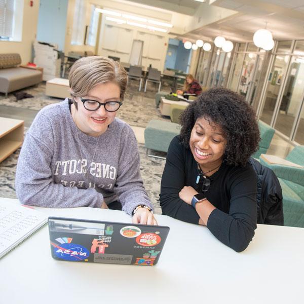 Two students at a laptop